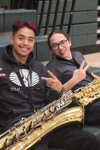 Two students posing with musical instruments