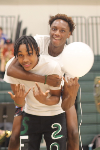 Two students posing in gym